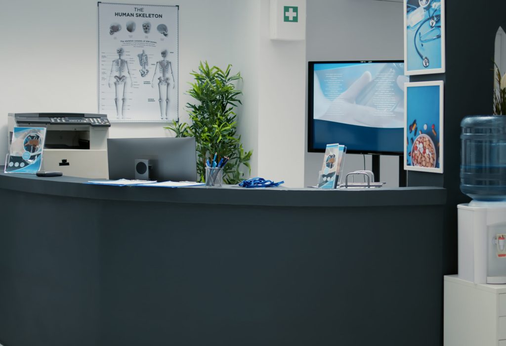 nobody-empty-waiting-room-lobby-with-desktop-reception-helping-patients-with-medical-insurance-attend-checkup-visit-appointment-waiting-area-with-counter-hospital-scaled.jpg